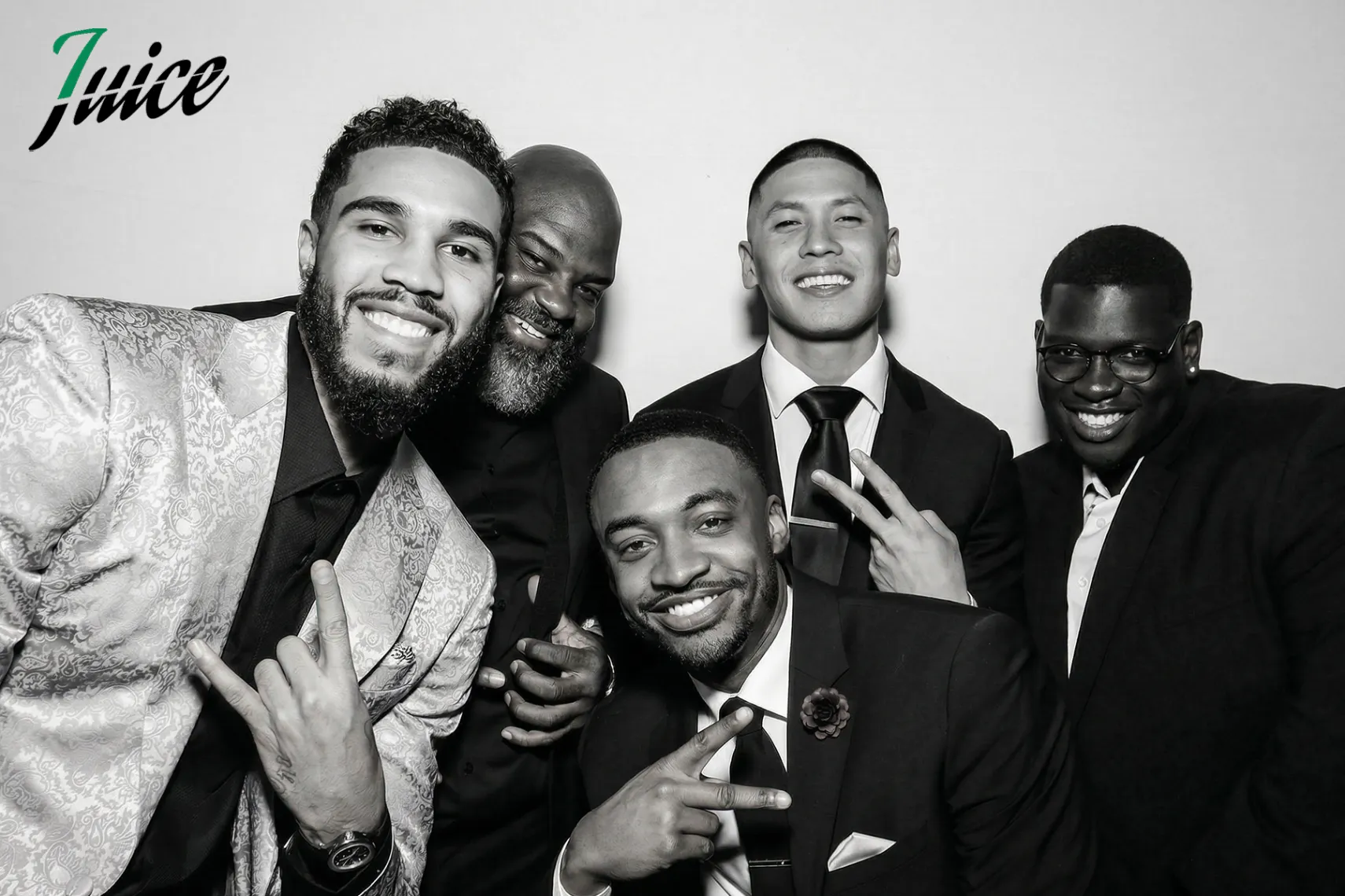 Corporate guests posing at a branded photo booth activation in a Boston venue